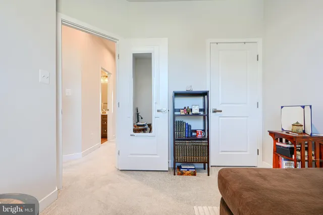 a bedroom with furniture and a book shelf