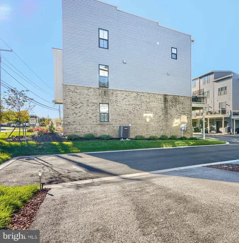 a front view of a building with a yard