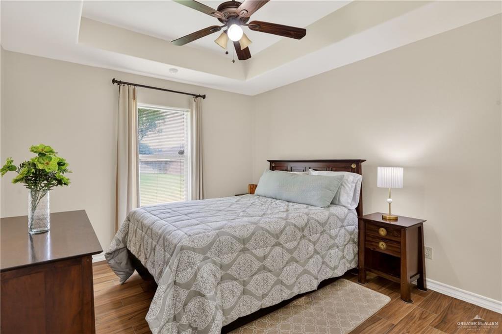 2305 Dilworth Road Harlingen, TX 78552 - Photo 9 of 16 a bedroom with a bed and a potted plant
