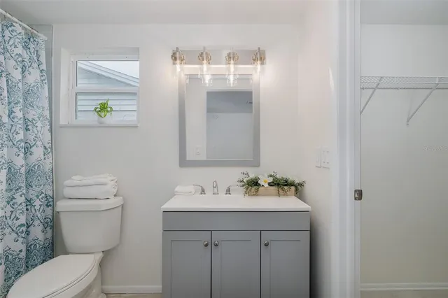 a bathroom with a shower curtain and a toilet