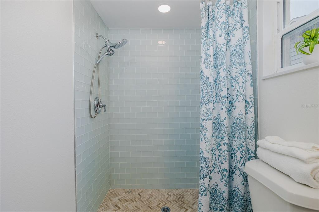 7437 Daggett Terrace New Port Richey, FL 34655 - Photo 24 of 38 a bathroom with a shower curtain and a toilet