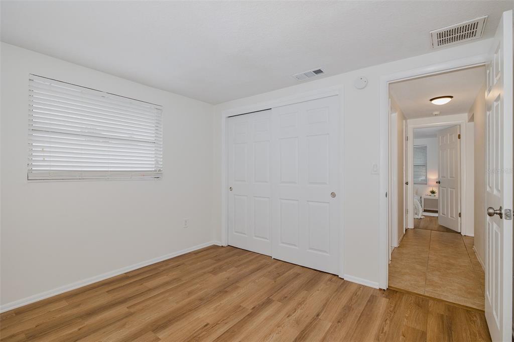 7437 Daggett Terrace New Port Richey, FL 34655 - Photo 29 of 38 a view of a room with wooden floor and a bathroom