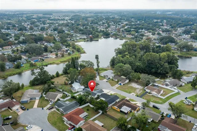 a view of an empty room with large windows and yard