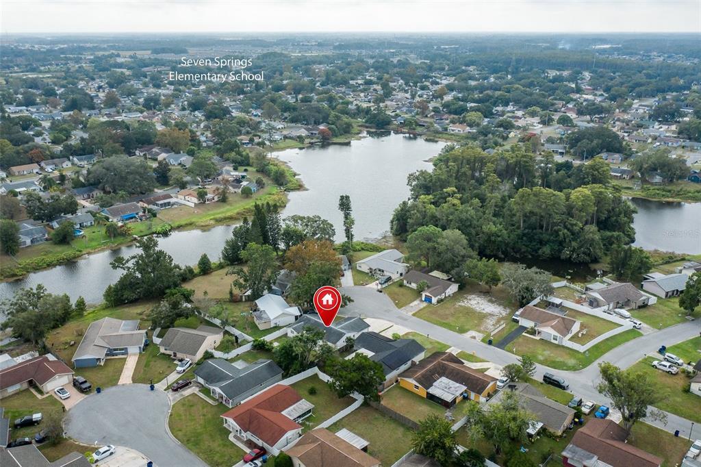 7437 Daggett Terrace New Port Richey, FL 34655 - Photo 32 of 38 an aerial view of a house with a lake view