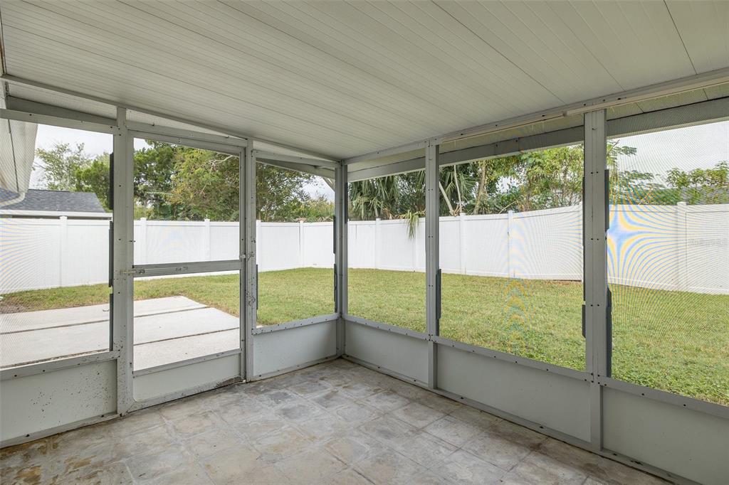 7437 Daggett Terrace New Port Richey, FL 34655 - Photo 34 of 38 a view of an empty room with large windows and yard