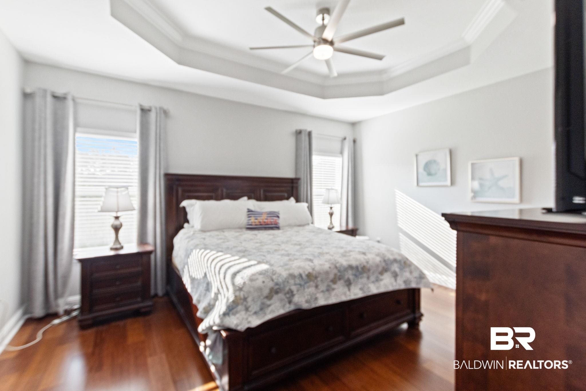 31541 Hoot Owl Road Daphne, AL 36527 - Photo 21 of 51 Bedroom featuring ceiling fan, dark hardwood / wood-style flooring, and a raised ceiling
