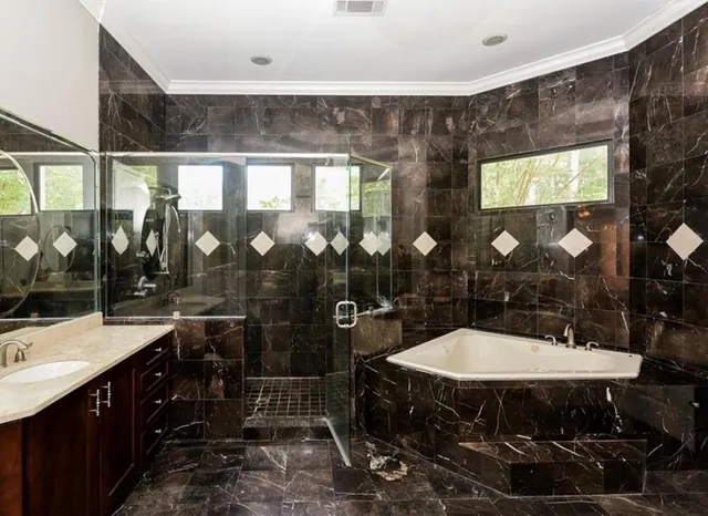 a bathroom with a sink a mirror and glass door