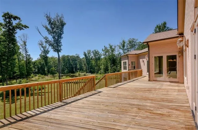 a view of house with backyard and deck