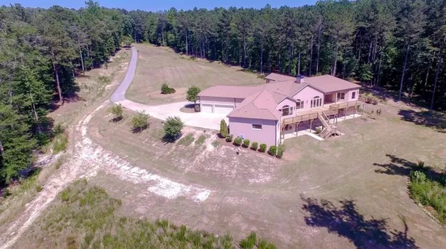 an aerial view of a house with a yard