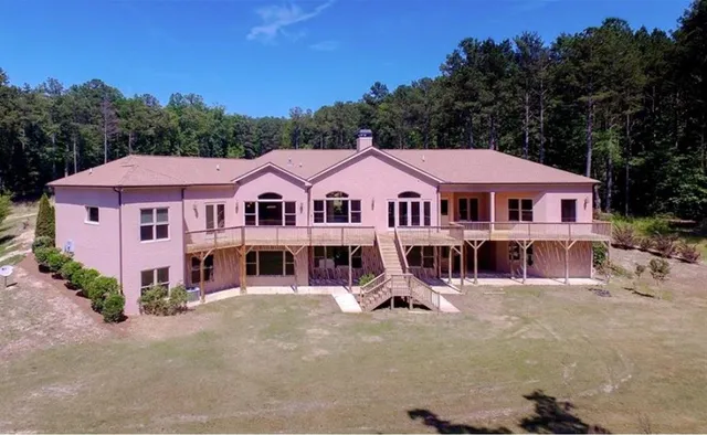a front view of a residential houses with yard and trees