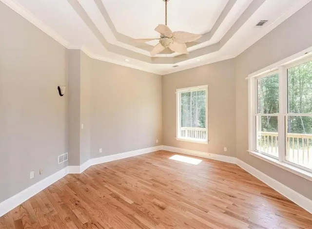 a view of a livingroom with a window and wooden floor