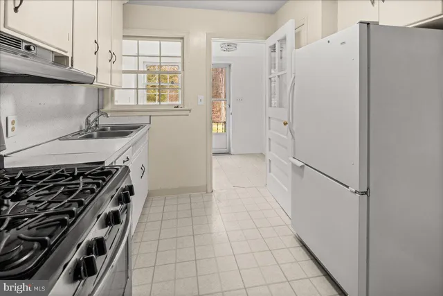 a kitchen with granite countertop a stove and a sink