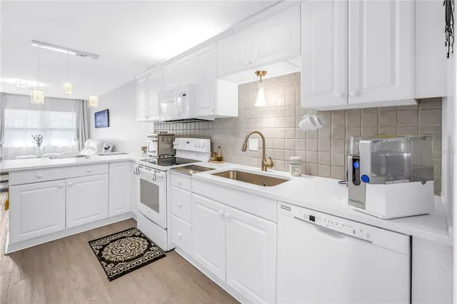 a kitchen with sink cabinets and a stove top oven