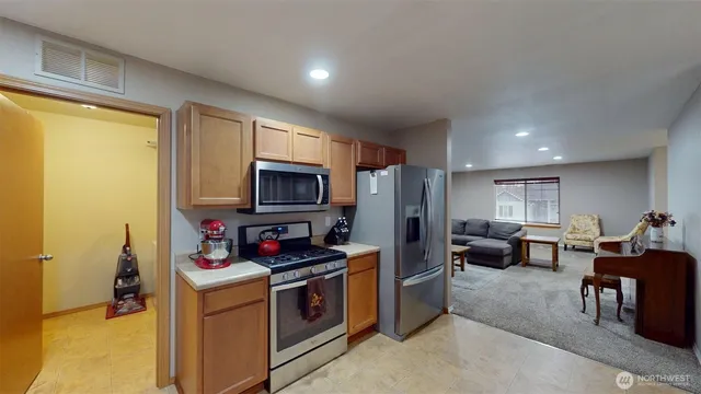 a kitchen that has a refrigerator stove and a sink