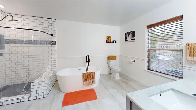 a spacious bathroom with a sink and a mirror
