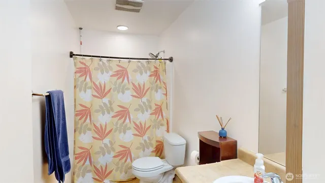 a white toilet sitting next to a bathroom sink