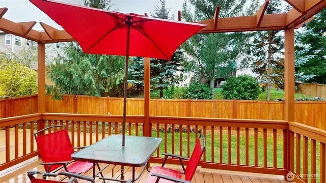 a view of a balcony with furniture and a yard