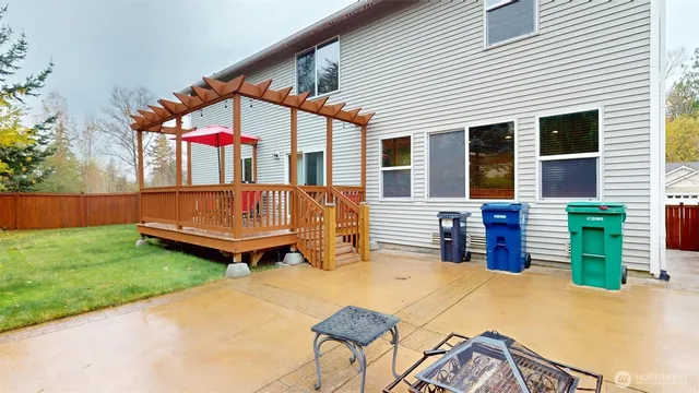 a backyard of a house with barbeque oven table and chairs