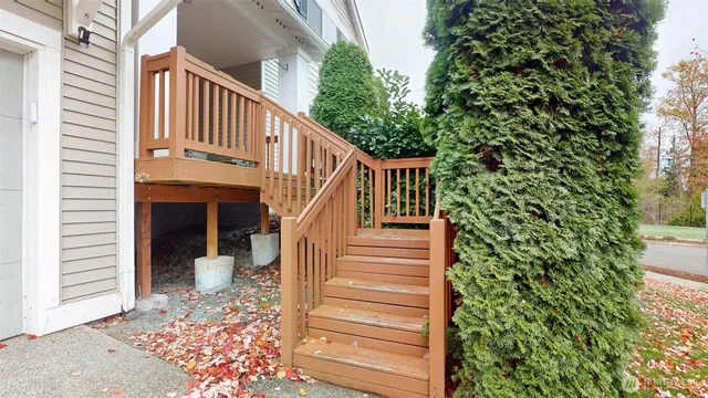 a view of a balcony with wooden floor and plants