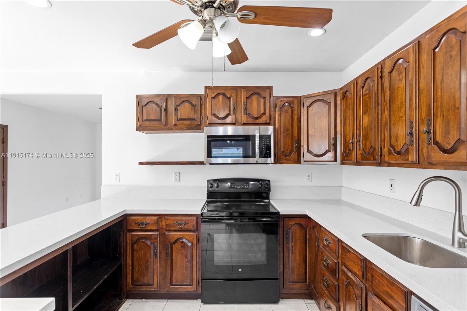 10605 Southwest 112th Street Miami, FL 33176 - Photo 12 of 44 a kitchen with stainless steel appliances granite countertop a sink and cabinets