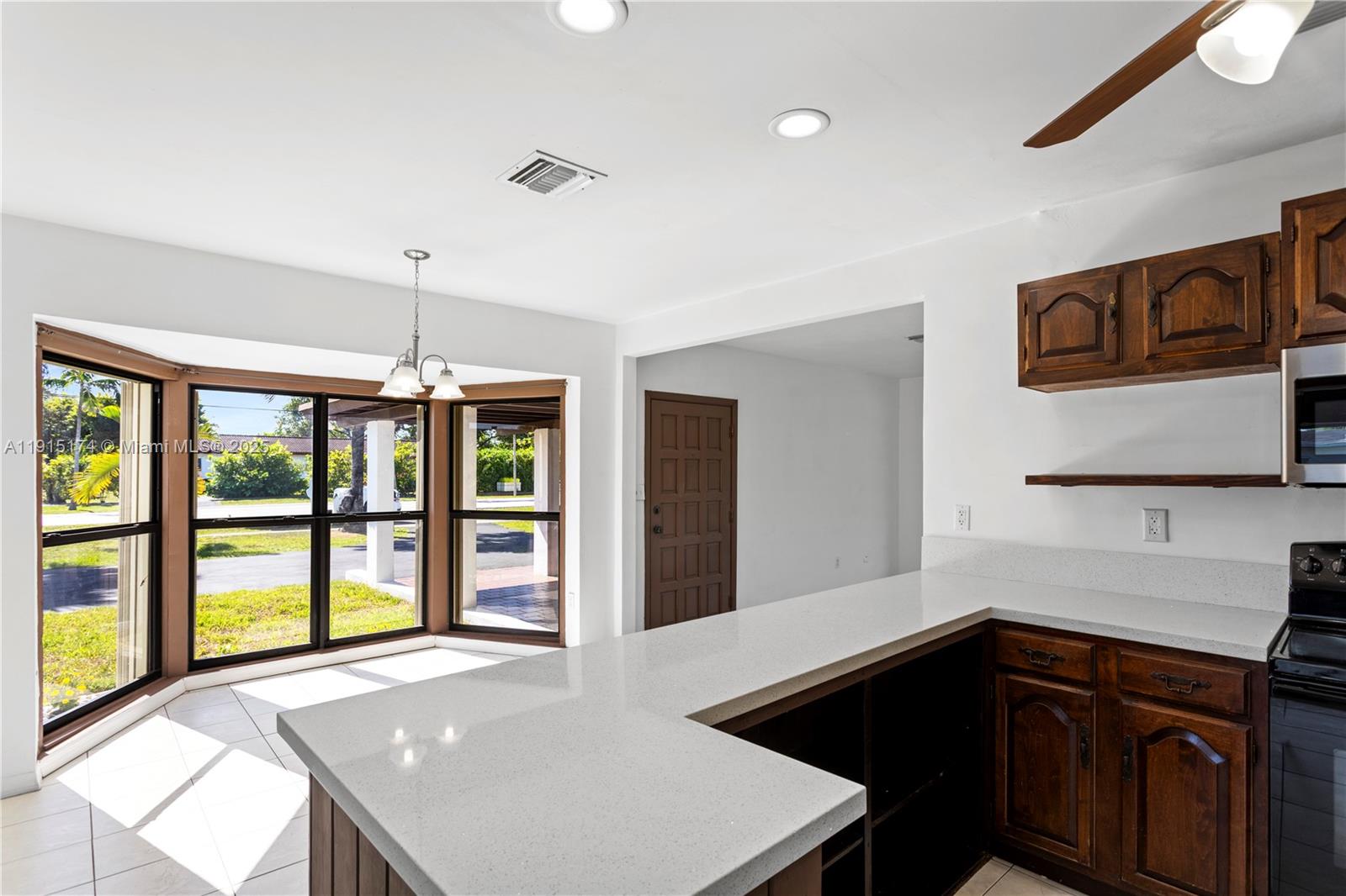 10605 Southwest 112th Street Miami, FL 33176 - Photo 13 of 44 a kitchen that has a sink and a stove in it