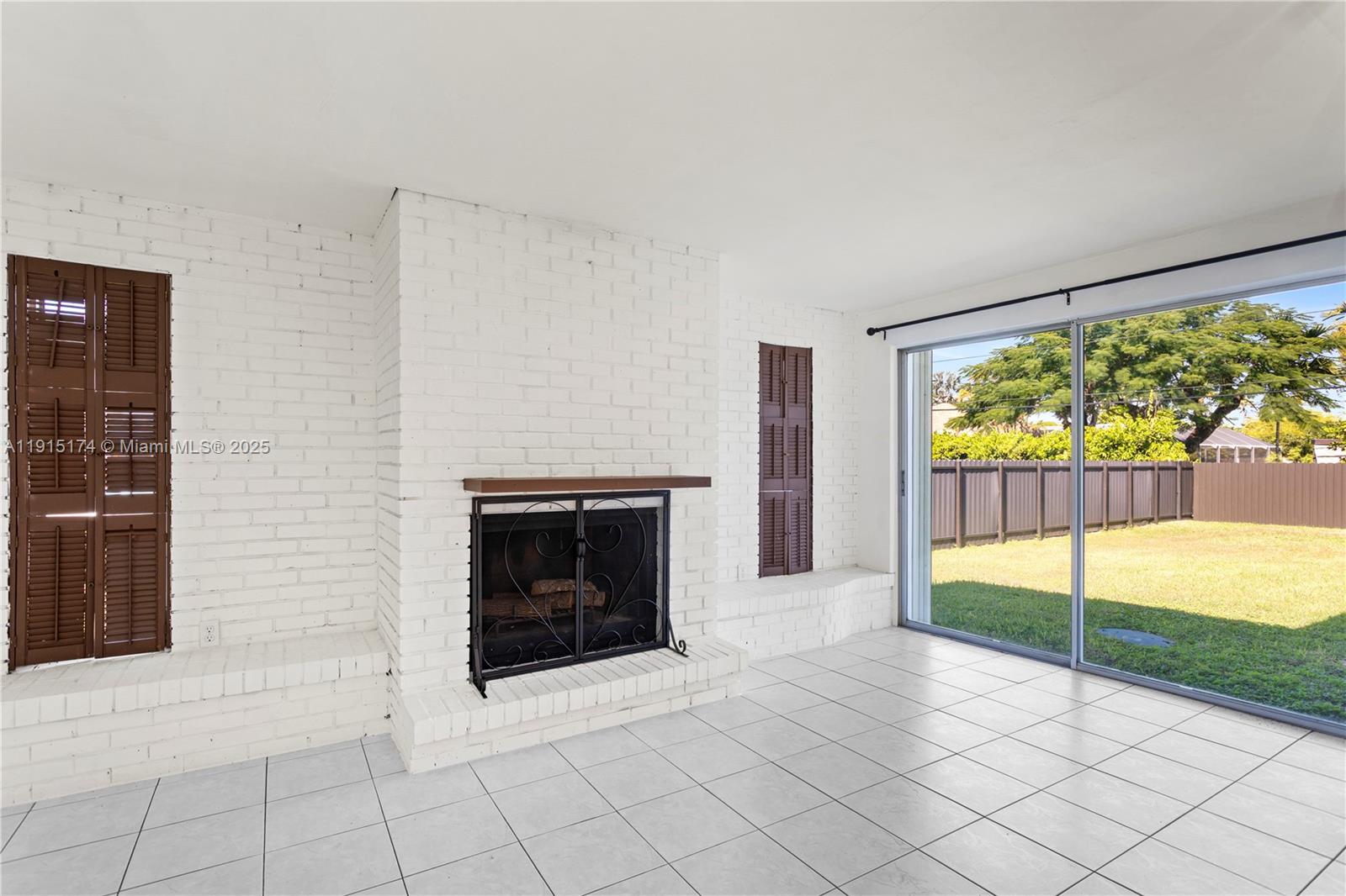 10605 Southwest 112th Street Miami, FL 33176 - Photo 15 of 44 a view of an empty room with a fireplace and a window