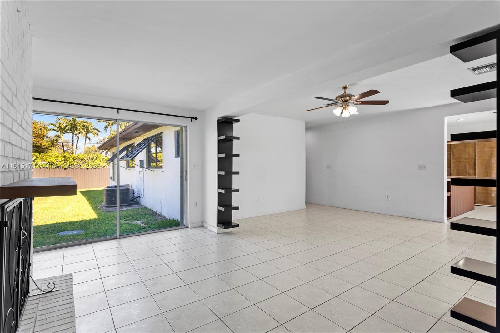 10605 Southwest 112th Street Miami, FL 33176 - Photo 16 of 44 a view of empty room with window and fireplace