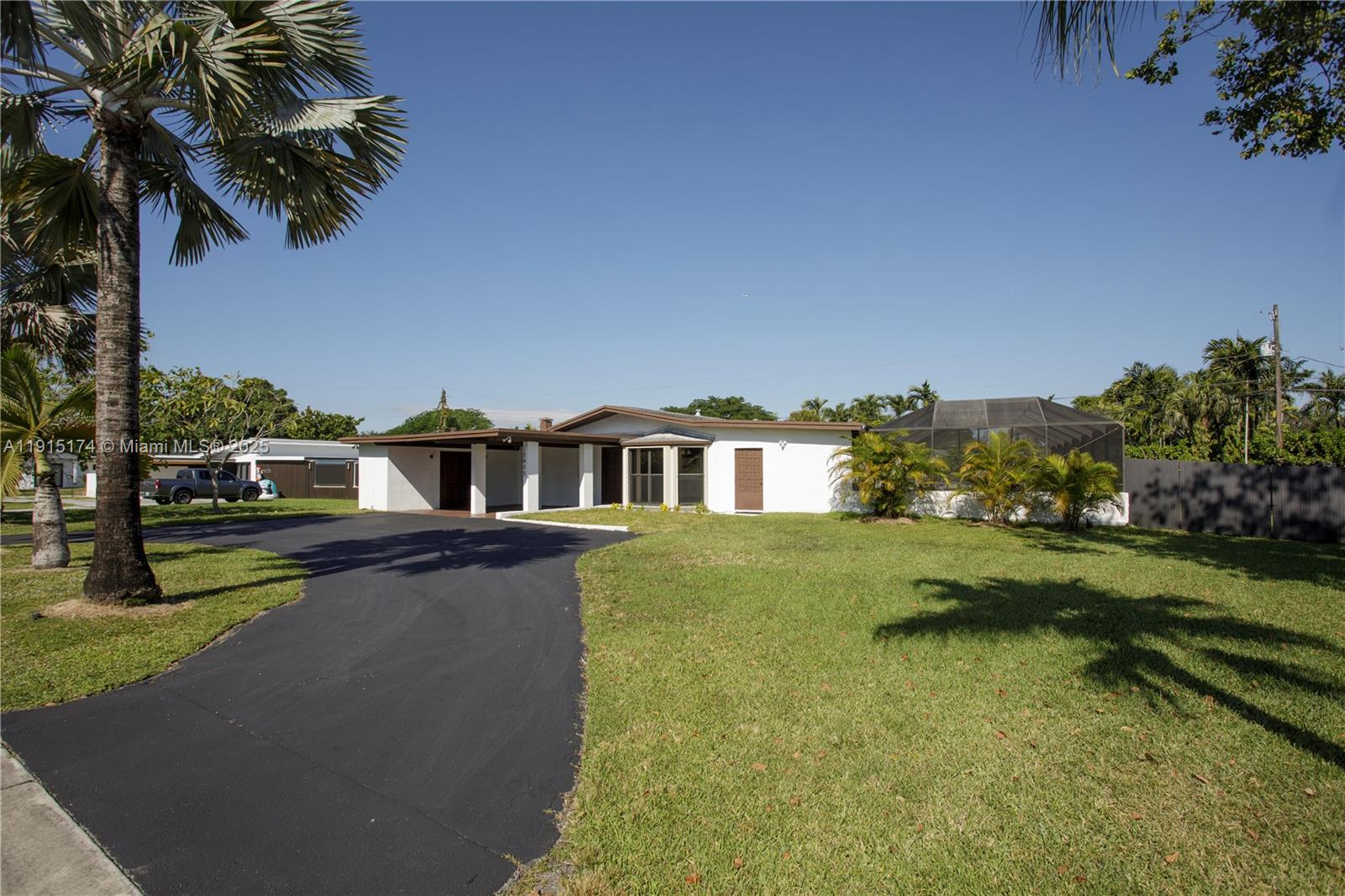 10605 Southwest 112th Street Miami, FL 33176 - Photo 2 of 44 a view of a house with pool and a yard