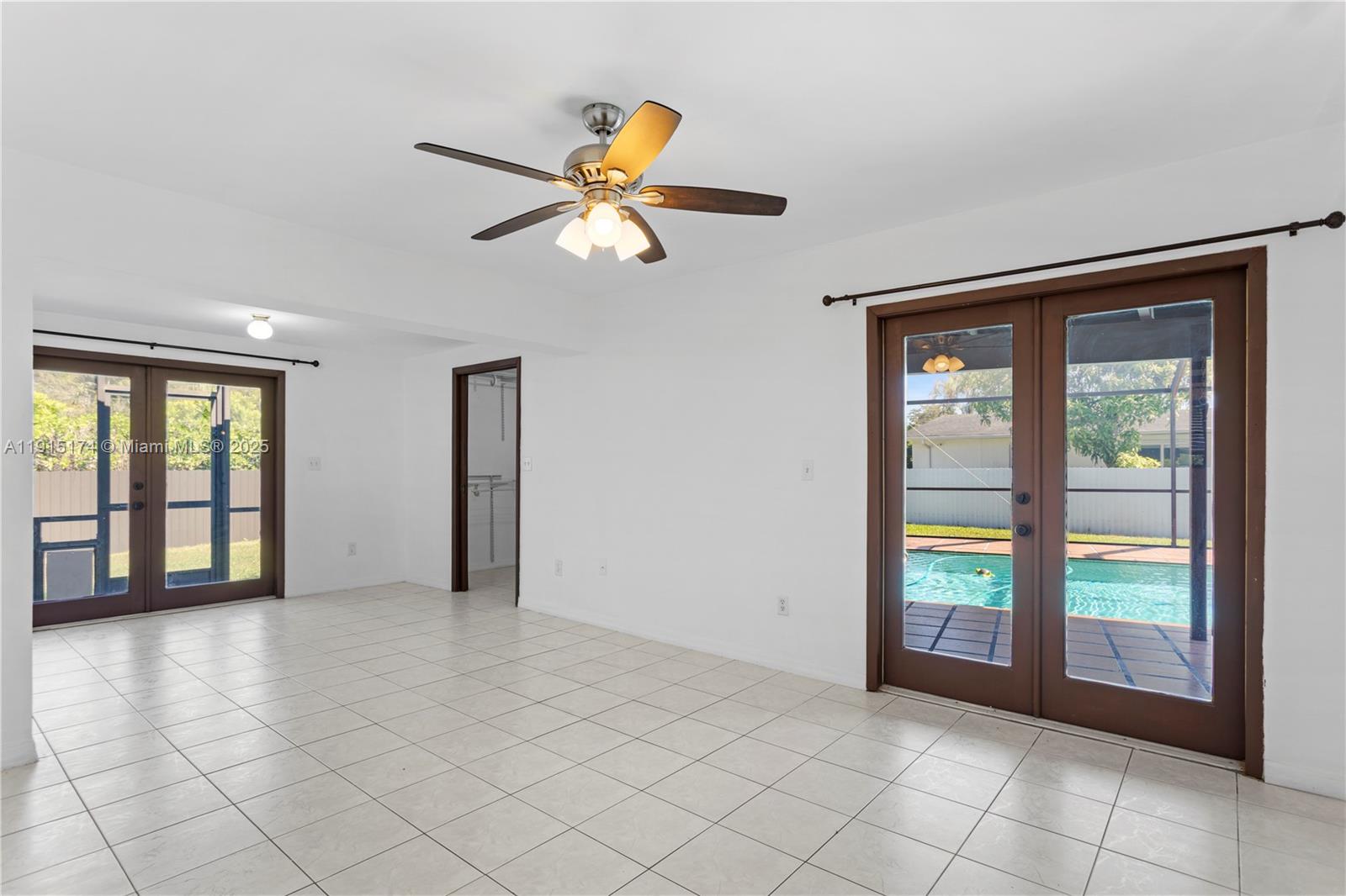 10605 Southwest 112th Street Miami, FL 33176 - Photo 21 of 44 a view of an empty room with window and chandelier fan