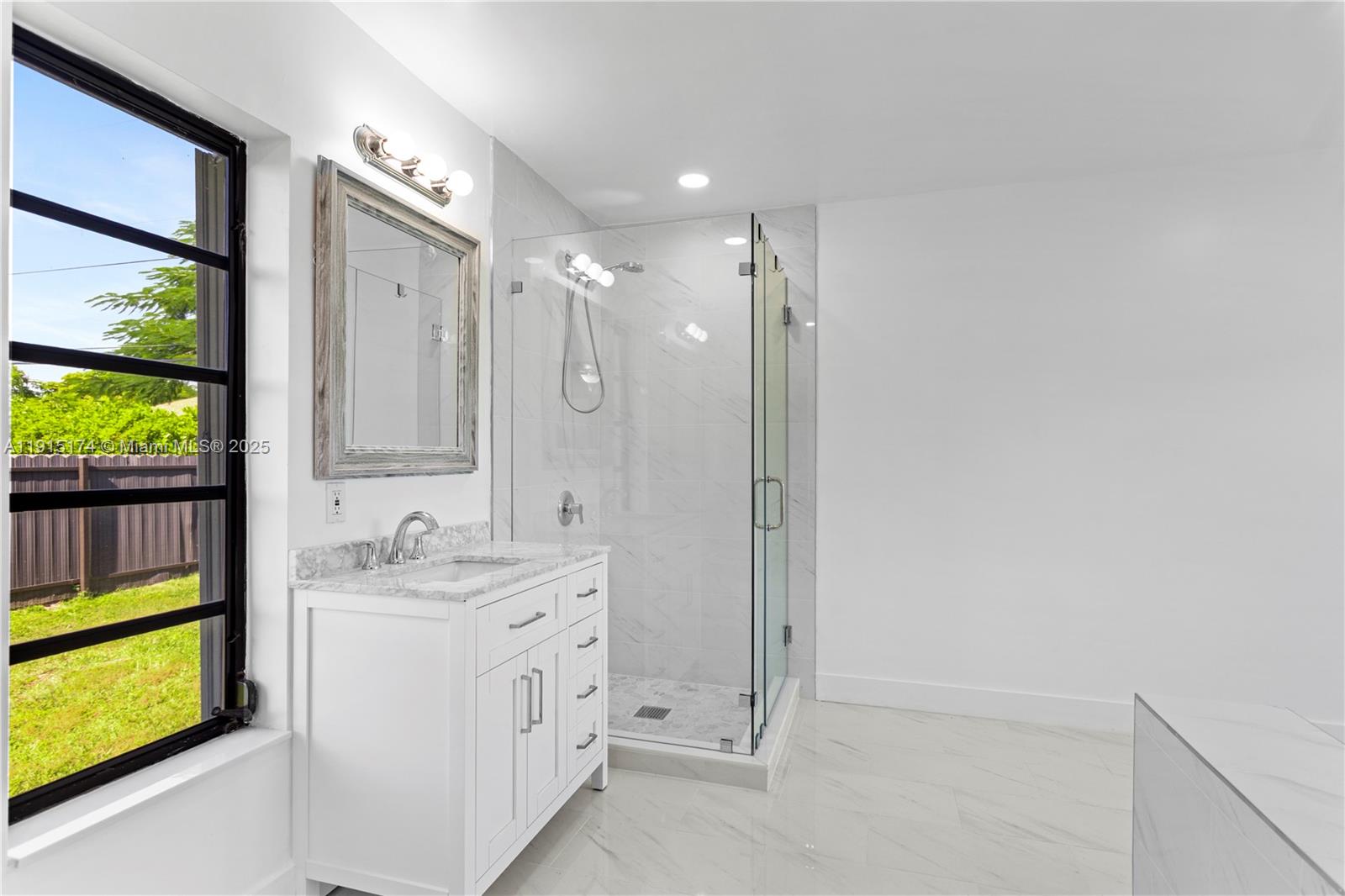 10605 Southwest 112th Street Miami, FL 33176 - Photo 28 of 44 a bathroom with a double vanity sink a mirror and a bathtub