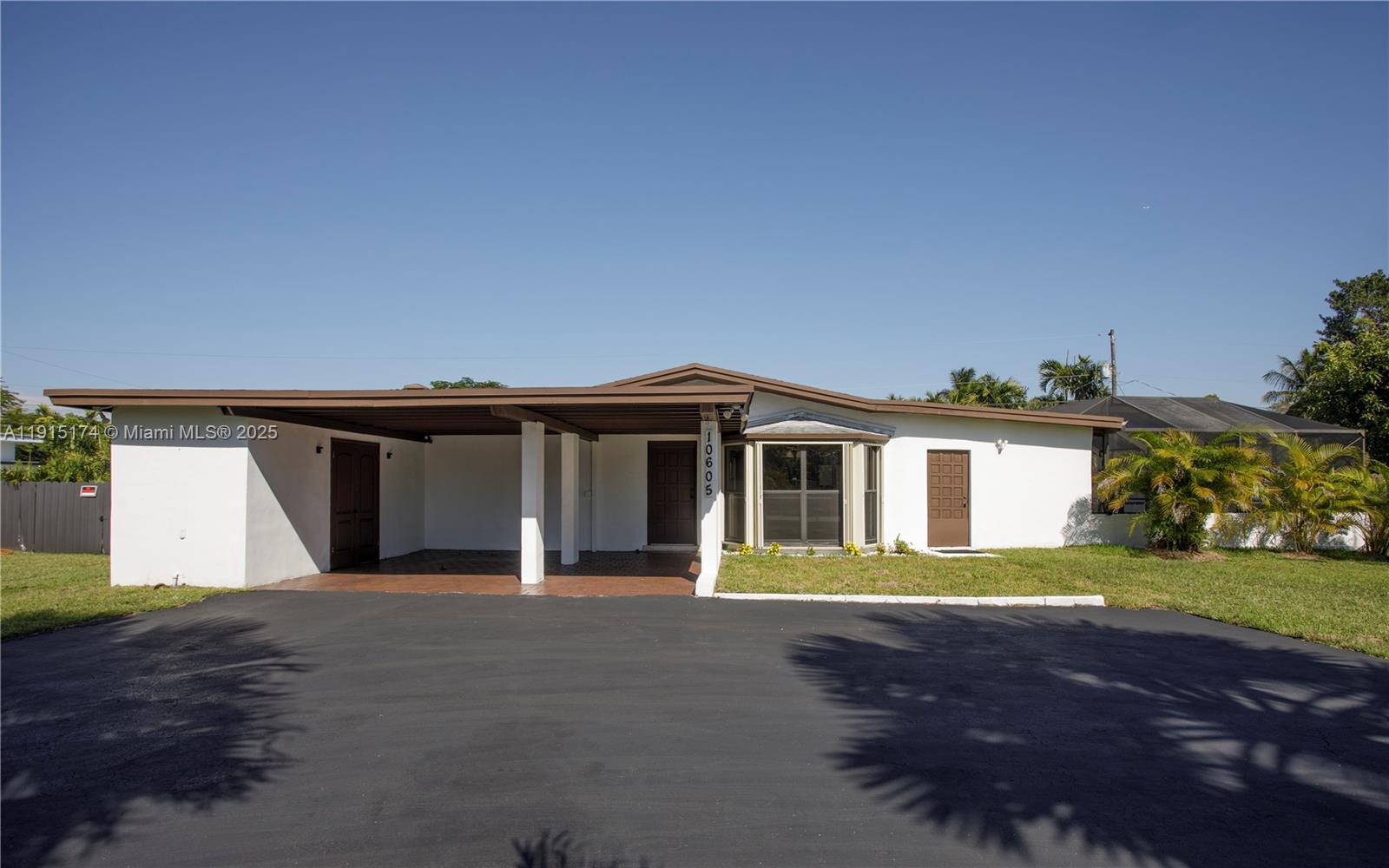 10605 Southwest 112th Street Miami, FL 33176 - Photo 3 of 44 a front view of a house with a garden and yard