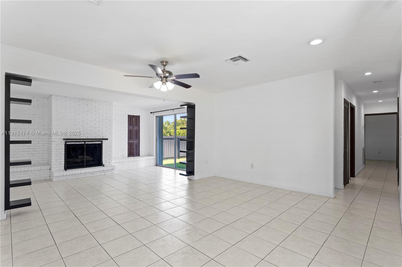 10605 Southwest 112th Street Miami, FL 33176 - Photo 7 of 44 an empty room with fireplace and fan