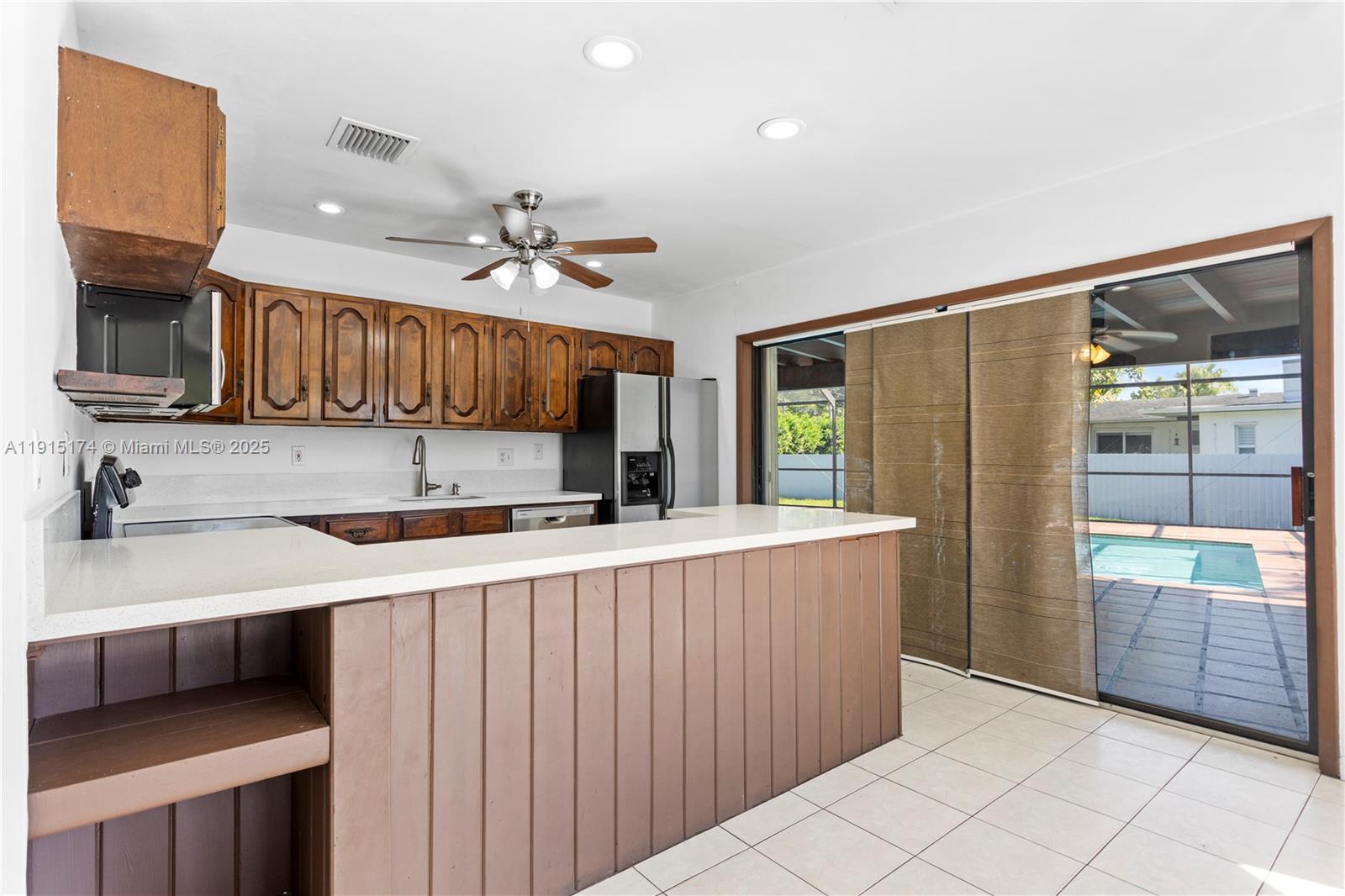 10605 Southwest 112th Street Miami, FL 33176 - Photo 10 of 44 a kitchen with stainless steel appliances a sink and a refrigerator