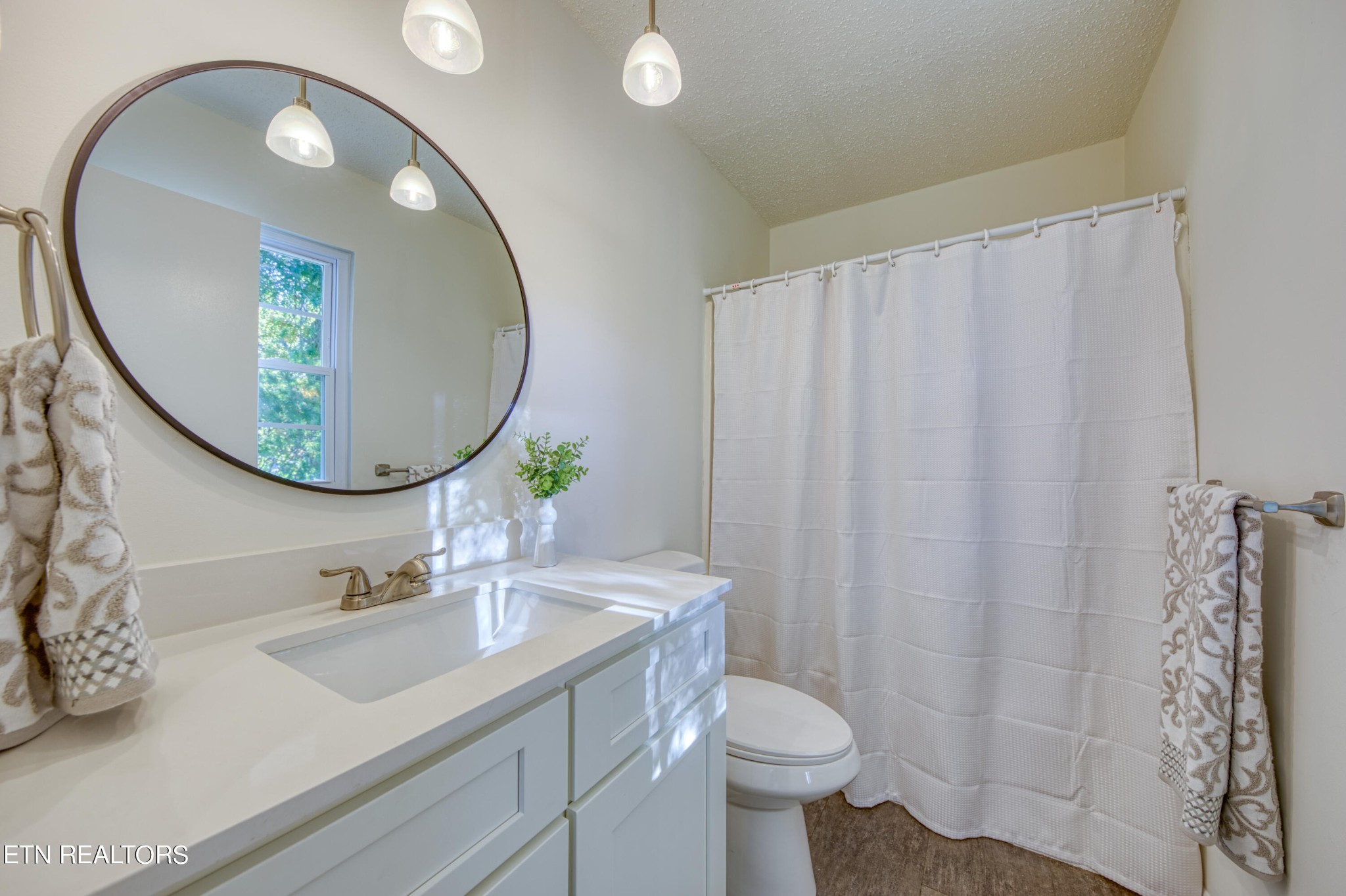 7329 Joyce Lane Powell, TN 37849 - Photo 14 of 28 a bathroom with a sink a mirror and a toilet