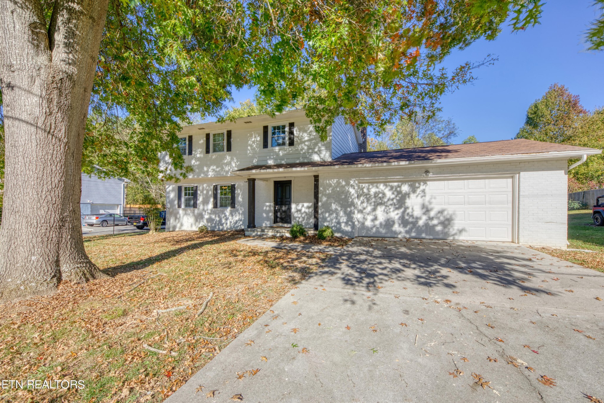 7329 Joyce Lane Powell, TN 37849 - Photo 27 of 28 a view of a white house with a large tree next to a yard