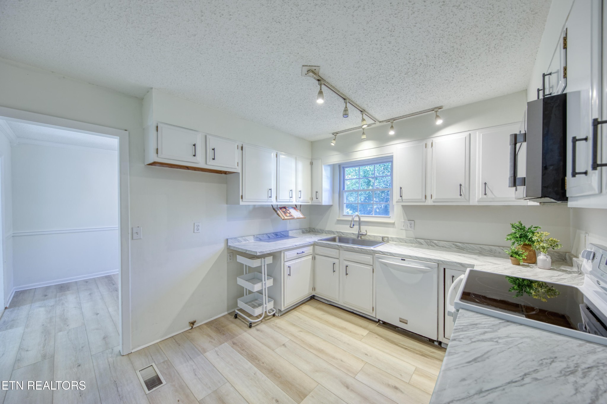7329 Joyce Lane Powell, TN 37849 - Photo 3 of 28 a kitchen with a sink cabinets and wooden floor