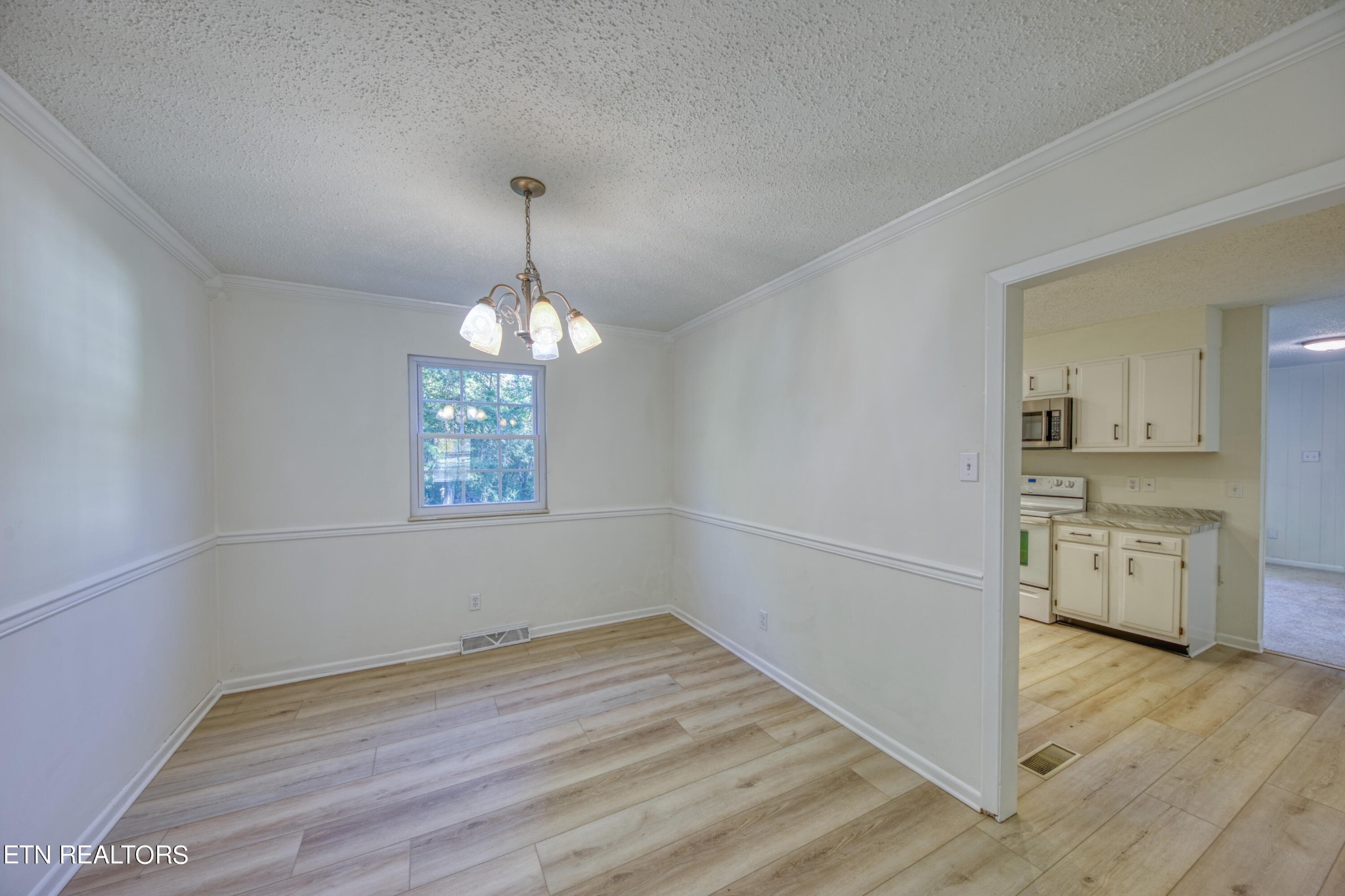 7329 Joyce Lane Powell, TN 37849 - Photo 5 of 28 wooden floor in an empty room with a window