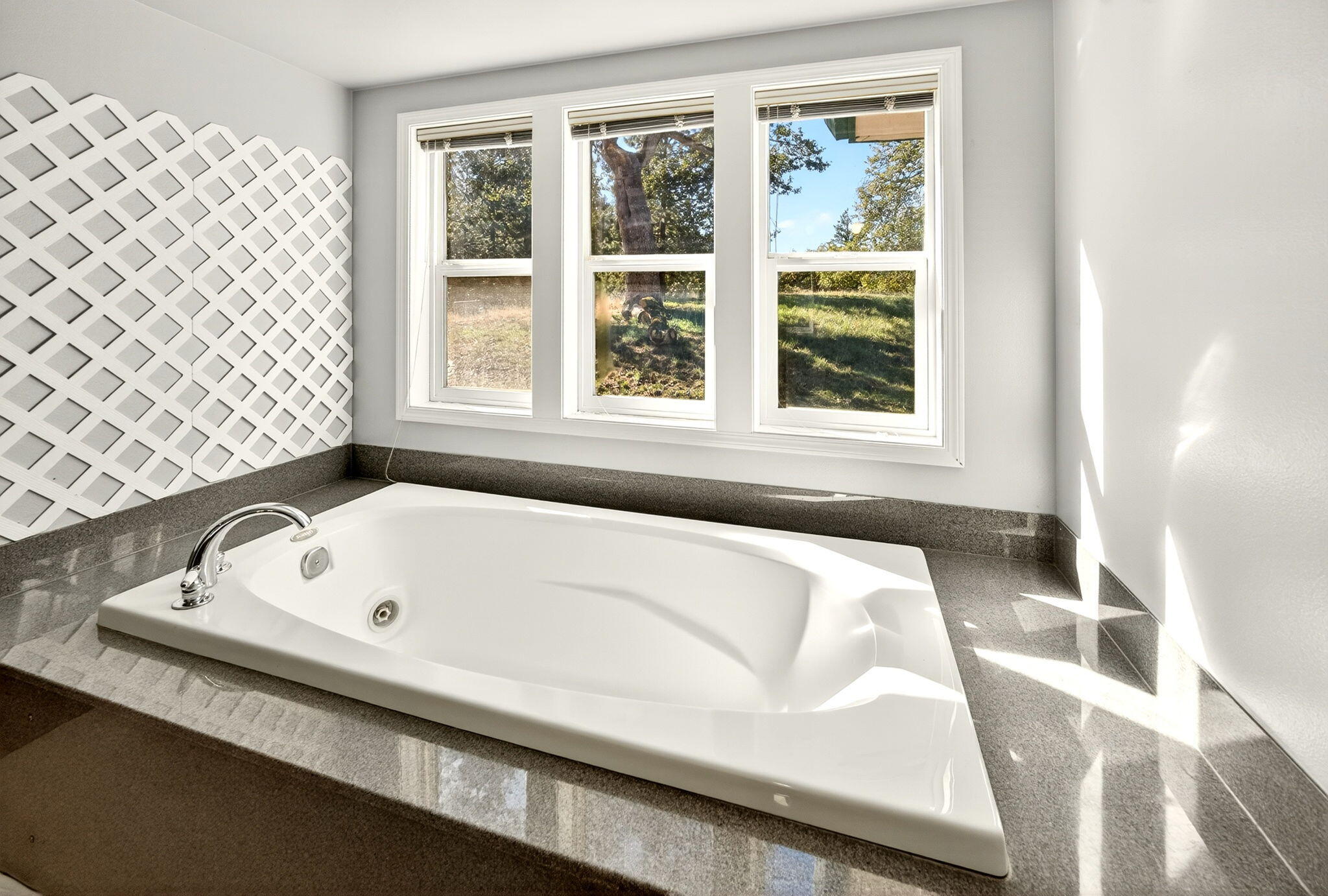 2467 Eastside Road Jacksonville, OR 97530 - Photo 74 of 85 a bathroom with a bathtub and next to a window