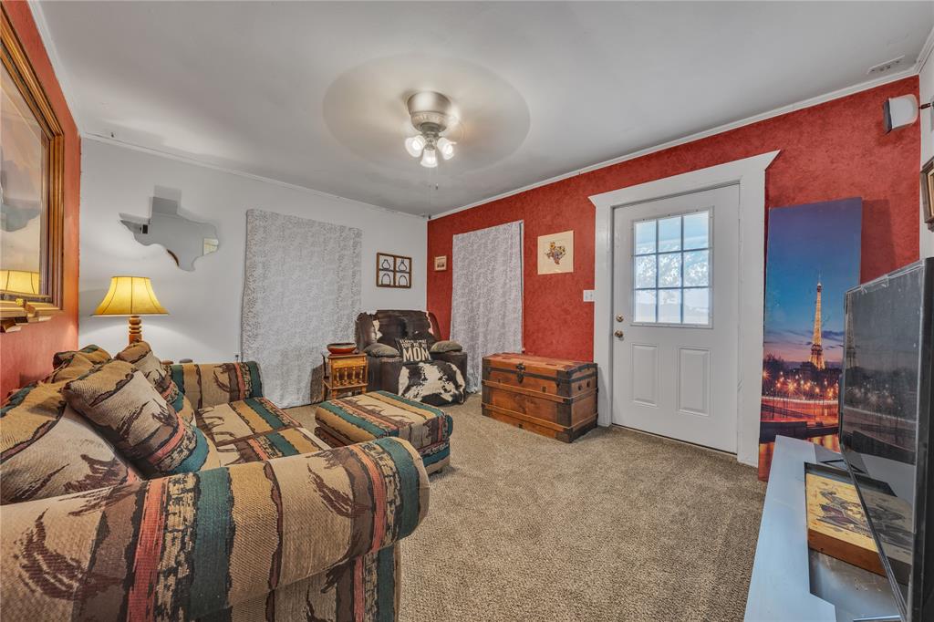 209 Dixie Road Millsap, TX 76066 - Photo 23 of 31 a bedroom with two beds and a chandelier