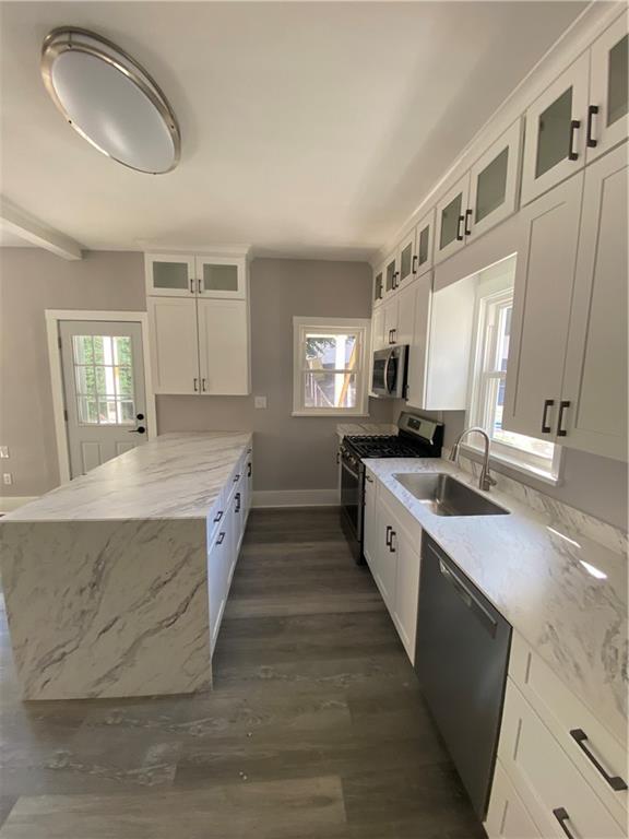 311 South 3rd Avenue Elizabeth, PA 15037 - Photo 13 of 30 a large kitchen with a large counter top space a sink stainless steel appliances and cabinets