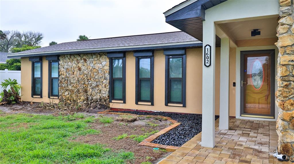 1602 South Riverside Drive Edgewater, FL 32132 - Photo 1 of 44 a front view of a house with garden