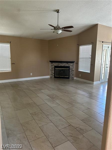 2600 Shakespeare Road Las Vegas, NV 89108 - Photo 2 of 6 A corner fireplace with a tiled surround anchors this spacious living area.