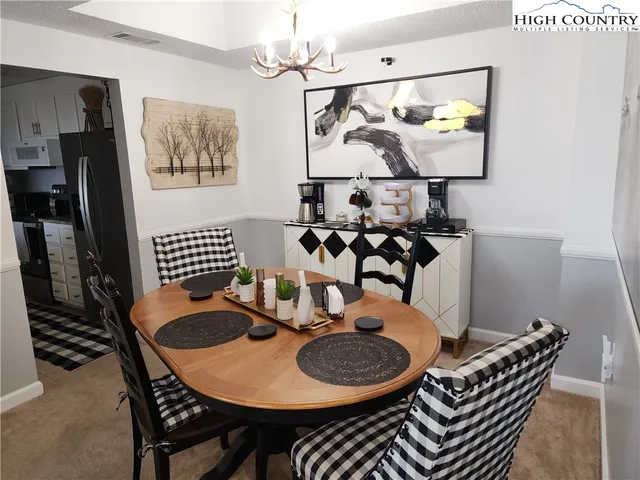 a dining room with furniture and wooden floor