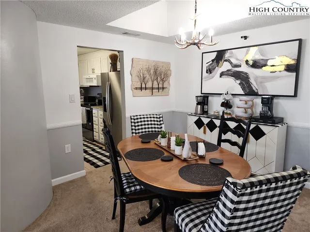 a dining room with furniture and window