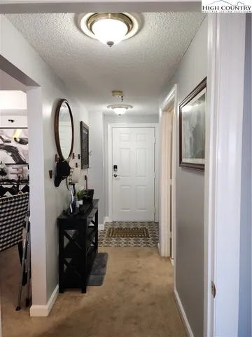 a view of a bathroom with a tub shower and mirror