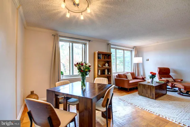a dining room with furniture and wooden floor
