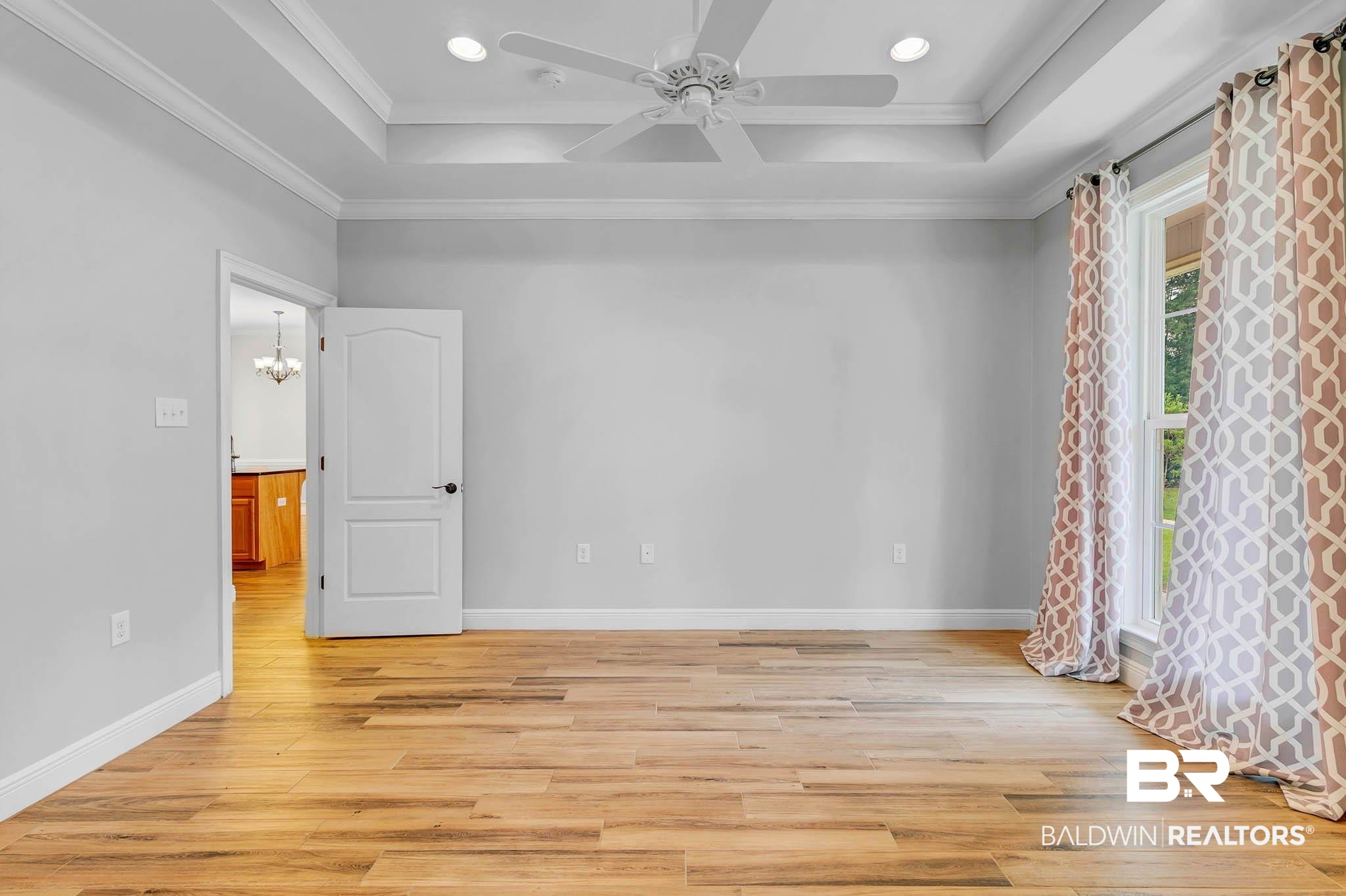 8145 Bay View Drive Foley, AL 36535 - Photo 29 of 81 Primary Bedroom featuring light wood-tiled flooring, a tray ceiling, ceiling fan, crown molding, and recessed lighting