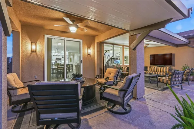 a view of a chair and tables in patio with potted plants