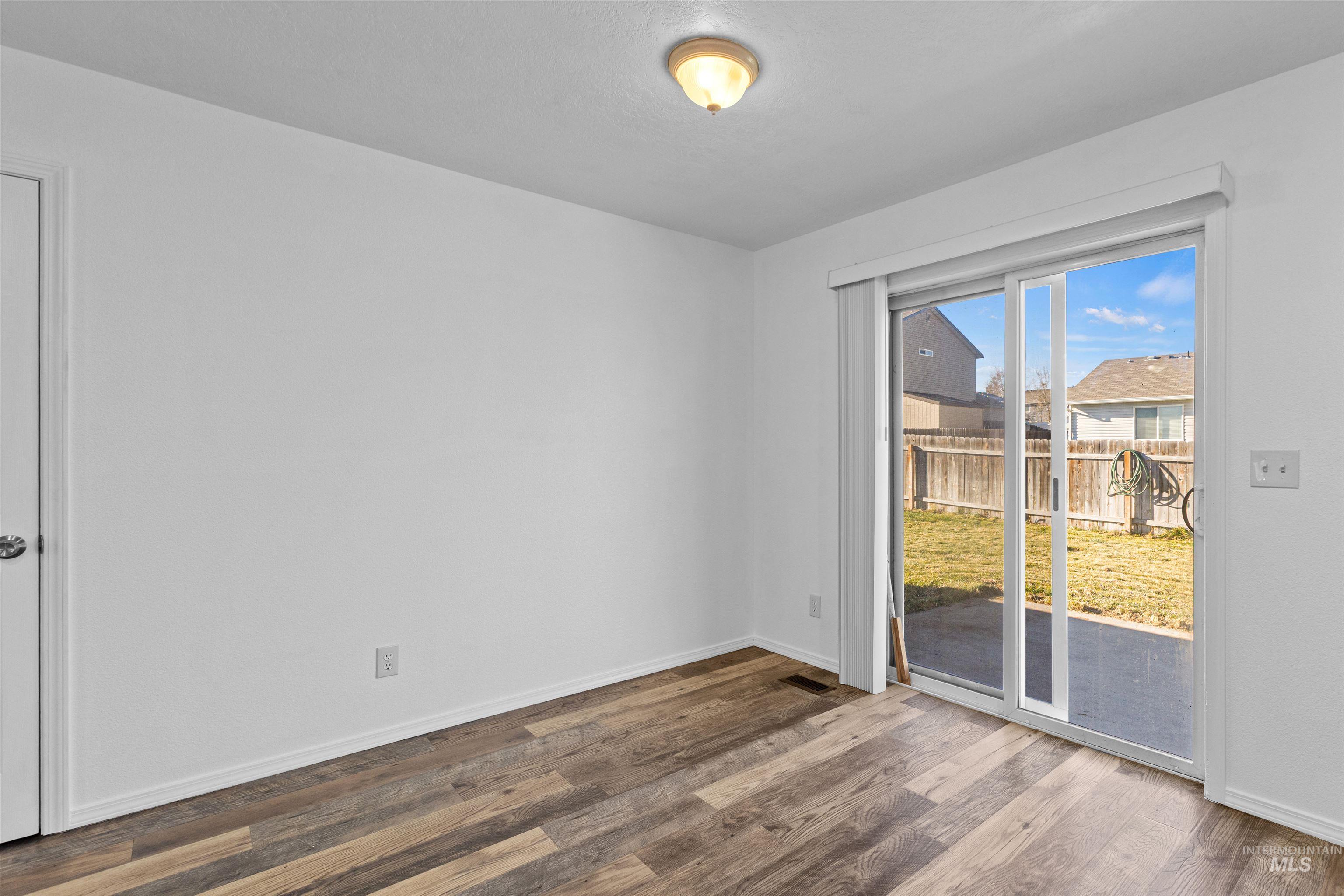 16535 Chino Avenue Caldwell, ID 83607 - Photo 15 of 26 Unfurnished room featuring wood finished floors and baseboards