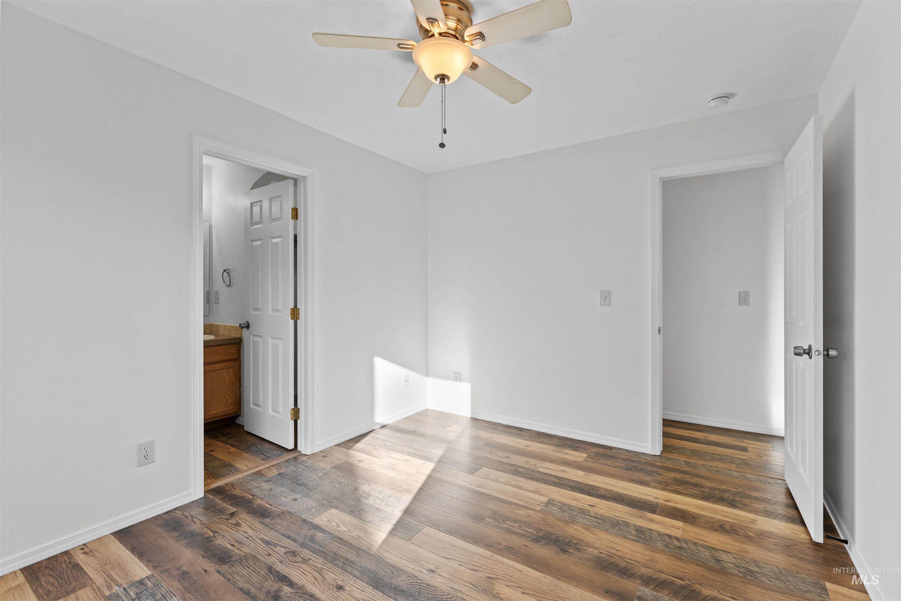 16535 Chino Avenue Caldwell, ID 83607 - Photo 20 of 26 Unfurnished bedroom featuring a ceiling fan, dark wood-style floors, and ensuite bathroom